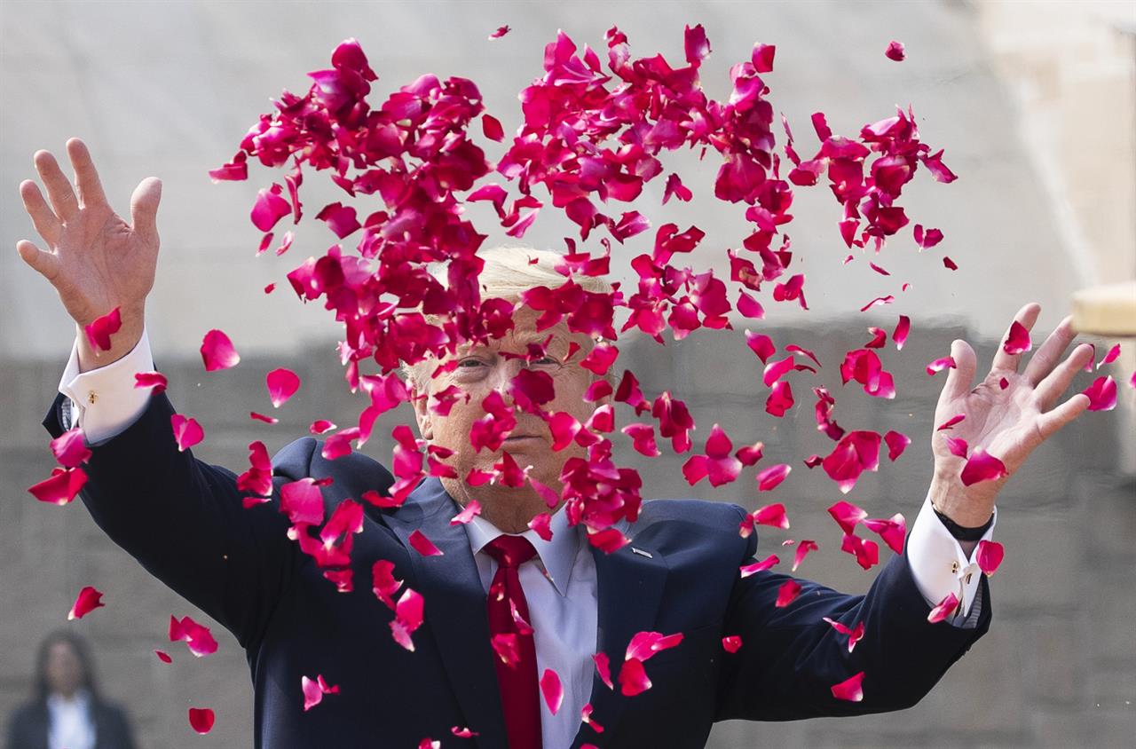 U.S. President Donald Trump offers floral respects at Raj Ghat, the memorial for Mahatma Gandhi, in New Delhi, India, Tuesday, Feb. 25, 2020. (AP Photo/Alex Brandon)
10 Things to Know for Today