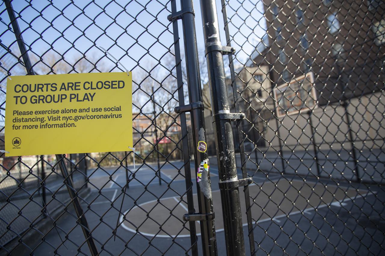 The West Fourth Street Courts, also known as "The Cage", are seen closed with the basketball hoops removed, Thursday, March 26, 2020, in New York. Across the U.S., police departments are taking a lead role in enforcing social distancing rules that health officials say are critical to containing the coronavirus. In New York City, they've started dismantling basketball hoops to prevent people from gathering in parks and playing. (AP Photo/Mary Altaffer)
A new beat for police across US: Enforcing social distance