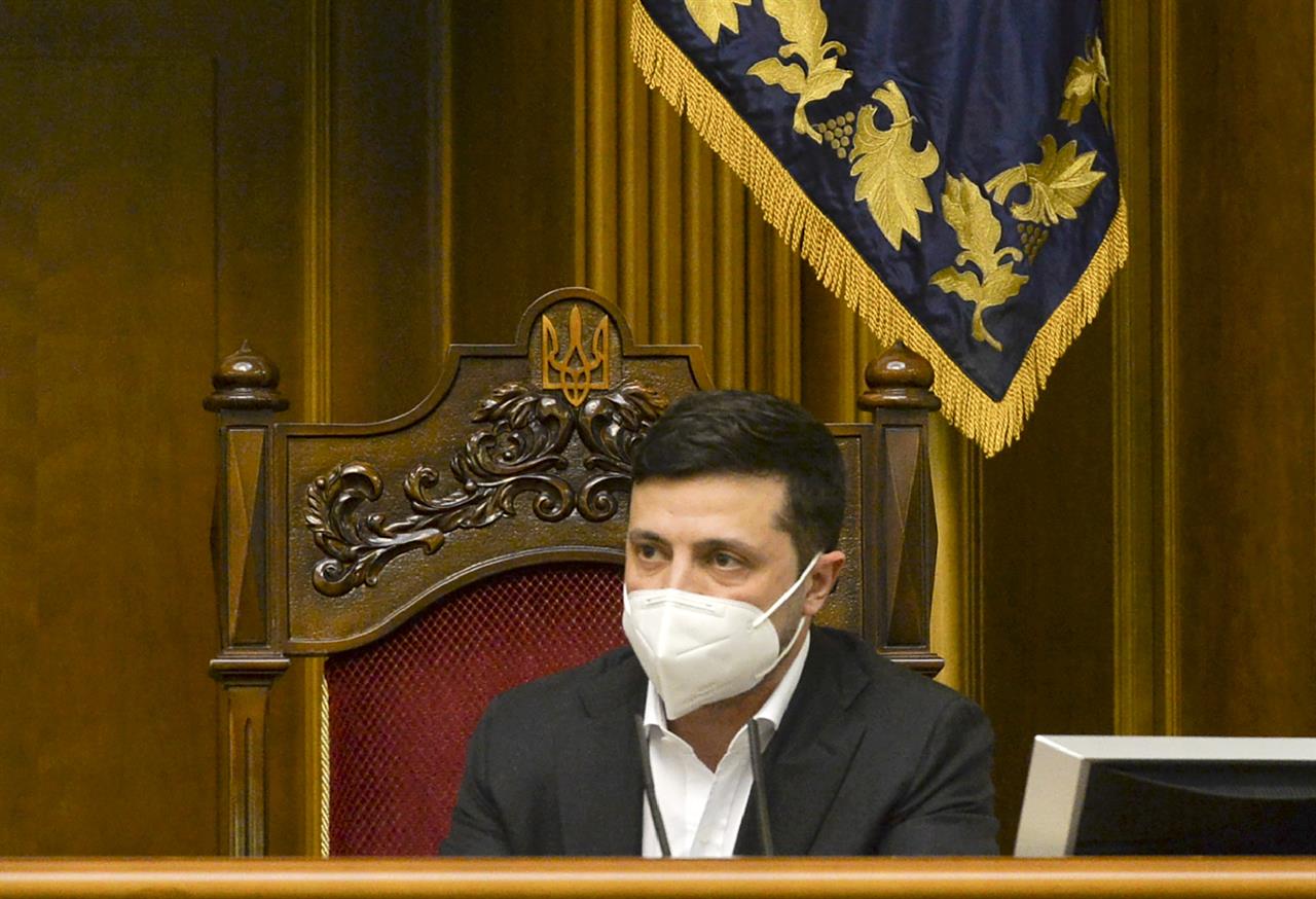 Ukrainian President Volodymyr Zelenskiy wearing a face mask to protect against coronavirus speaks during an extraordinary parliamentary session in Kyiv, Ukraine, Monday, March 30, 2020. Ukraine has been under quarantine since March 12. The new coronavirus causes mild or moderate symptoms for most people, but for some, especially older adults and people with existing health problems, it can cause more severe illness or death. (AP Photo)
Ukraine approves legislation in a bid for IMF aid