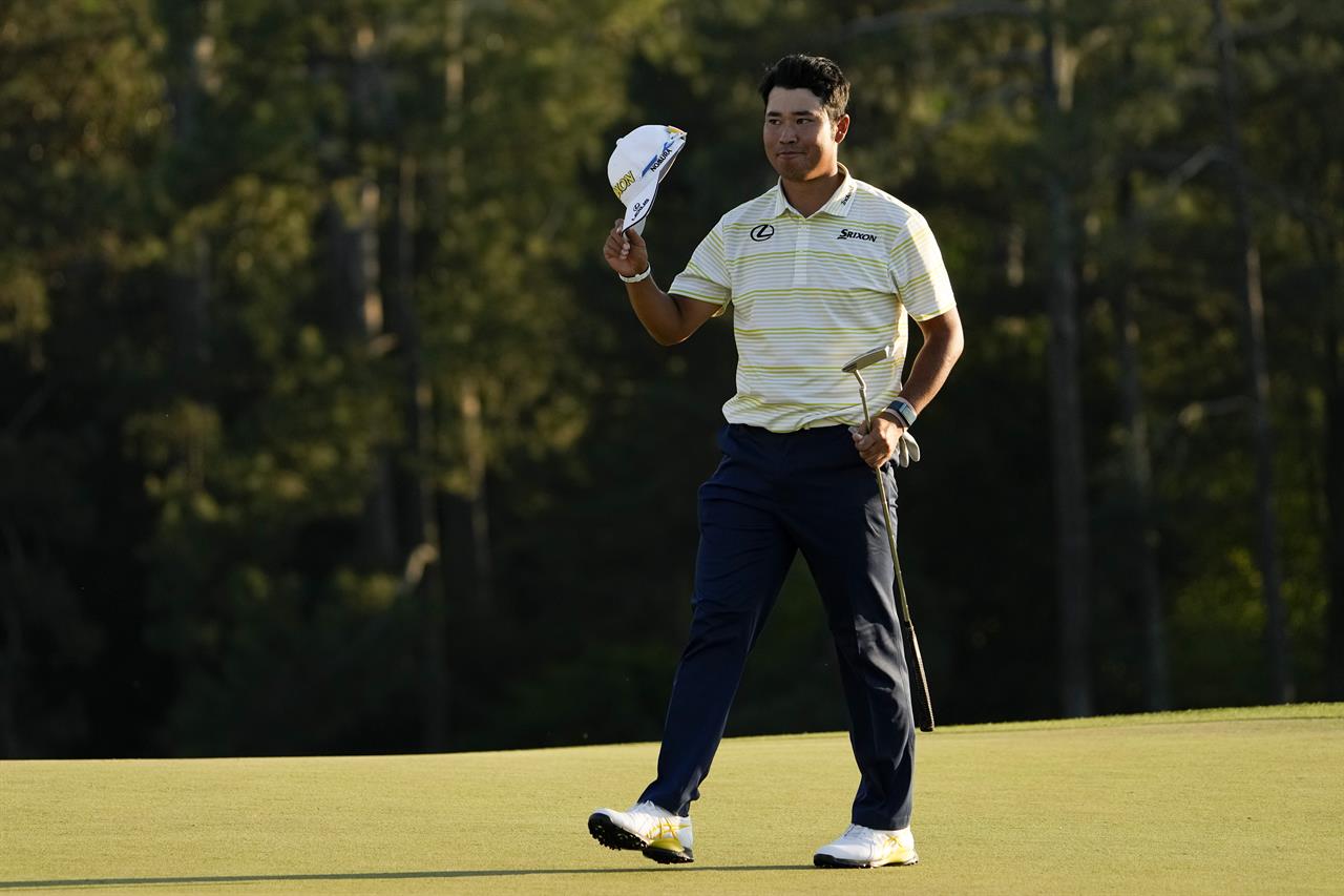 Hideki Matsuyama, of Japan, waves his cap after winning the Masters golf tournament on Sunday, April 11, 2021, in Augusta, Ga. (AP Photo/David J. Phillip)