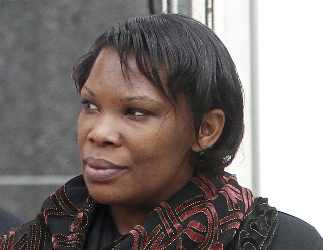 FILE- In this April 12, 2012 file photo Beatrice Munyenyezi leaves the Federal Court in Concord, N.H. Munyenyezi, who served a 10-year sentence in federal prison for lying about her role in the 1994 Rwanda genocide to obtain U.S. citizenship and lost her bid for a new trial has been deported to Rwanda, her lawyer said Saturday, April 17, 2021. Munyenyezi was convicted and sentenced in 2013 in New Hampshire. (AP Photo/Jim Cole,File)