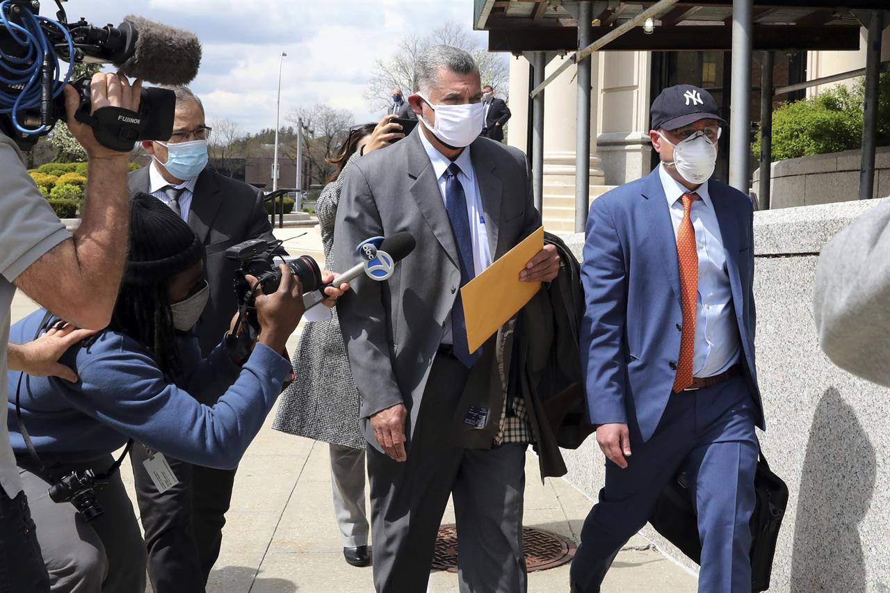Former police lieutenant-turned-lawyer Gustavo Vila, center, leaves federal court in White Plains, N.Y., on Monday, April 19, 2021. Vila was sentenced to more than four years in prison after cheating a fellow officer of $900,000 he was owed for working at the smoldering World Trade Center site after the Sept. 11 terrorist attacks. (Tania Savayan/The Journal News via AP)