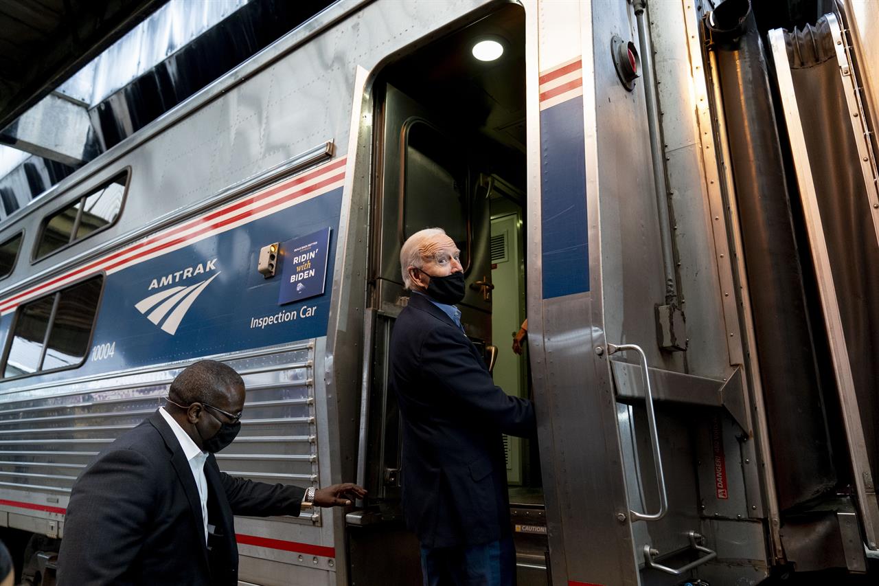 FILE - In this Sept. 30, 2020, file photo, then-Democratic presidential candidate former Vice President Joe Biden boards his train at Amtrak's Pittsburgh Train Station in Pittsburgh. President Joe Biden is set to help the nation's passenger rail system celebrate 50 years of service. (AP Photo/Andrew Harnik)