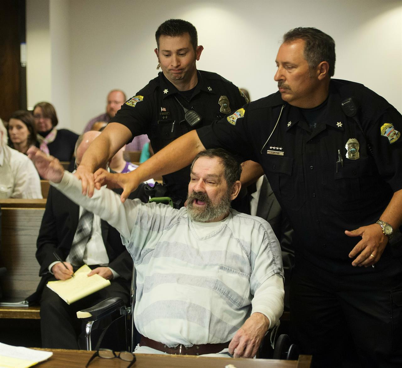 FILE - In this Nov. 10, 2015, file photo, Frazier Glenn Miller Jr., convicted of capital murder, attempted murder and other charges, gestures as Johnson County deputies remove Miller from the courtroom during the sentencing phase of his trial at the Johnson County District Court in Olathe, Kan. Miller, an avowed anti-Semite who fatally shot three people at Jewish sites in Kansas has died in prison, Monday, May 3, 2021, at the El Dorado Correctional Facility. (Joe Ledford/The Kansas City Star via AP, Pool, File)