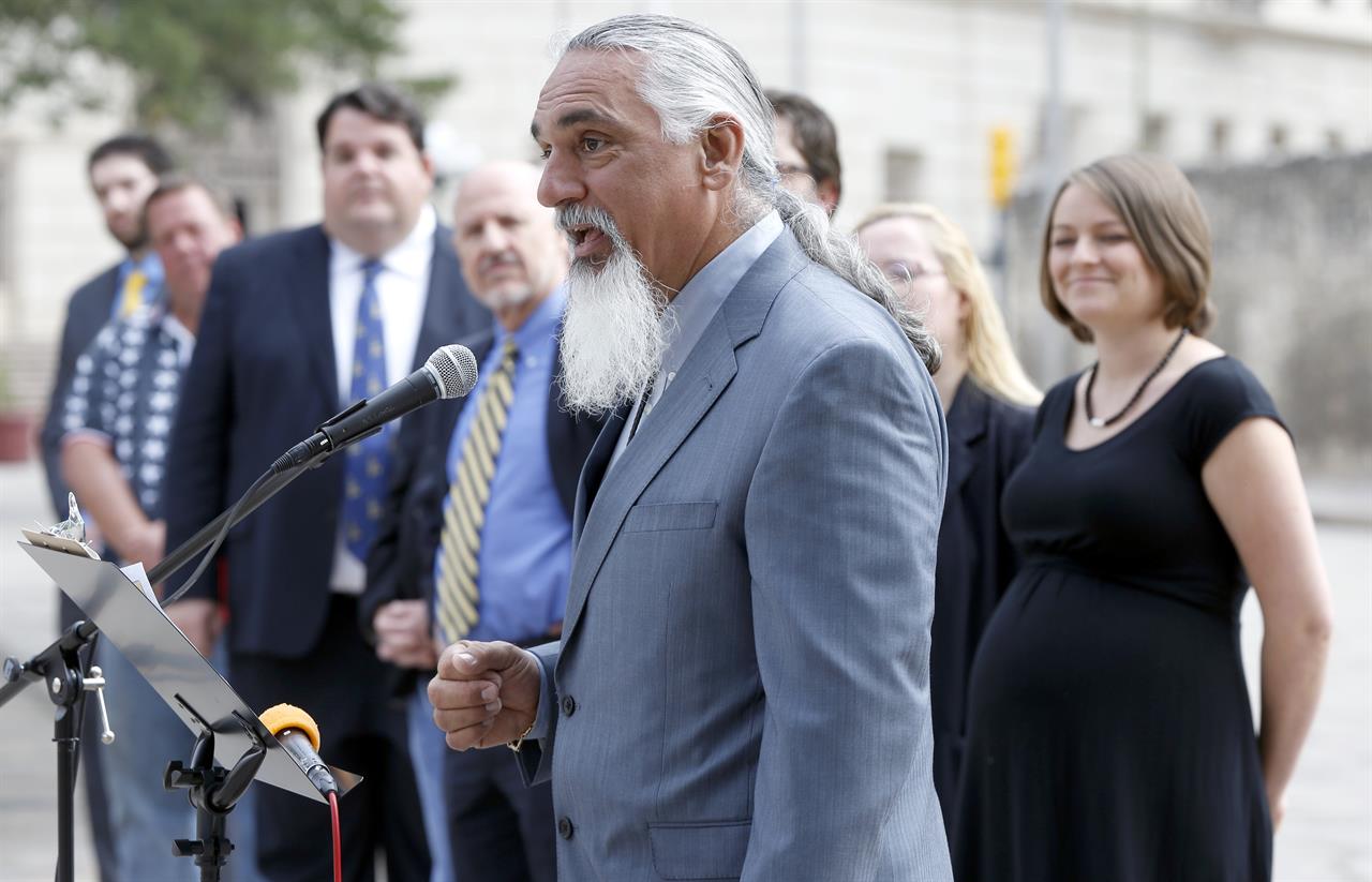 FILE - In this May 1, 2014 file photo, Libertarian party candidate for Texas attorney general Jamie Balagia speaks in front of the Alamo in San Antonio, Texas, about his election platform. Balagia, a Texas lawyer known as the "DWI Dude" has been sentenced to more than 15 years in federal prison for falsely promising Colombian drug traffickers he'd get their charges reduced in exchange for cash. Balagia was sentenced Monday, May, 3, 2021, to 188 months in federal prison. (William Luther/The San Antonio Express-News via AP)
