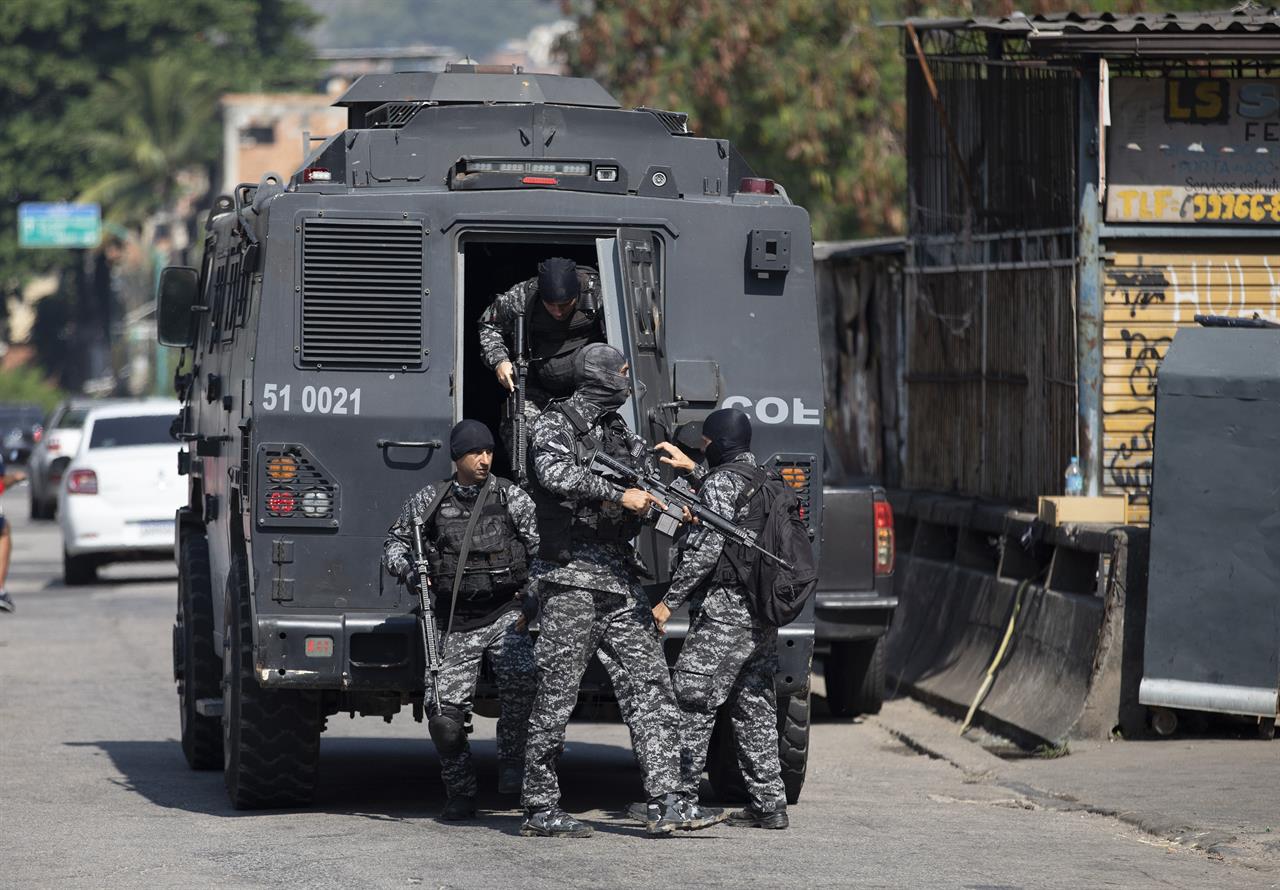 Police get out of an armored vehicle during an operation against alleged drug traffickers in the Jacarezinho favela of Rio de Janeiro, Brazil, Thursday, May 6, 2021. (AP Photo/Silvia Izquierdo)