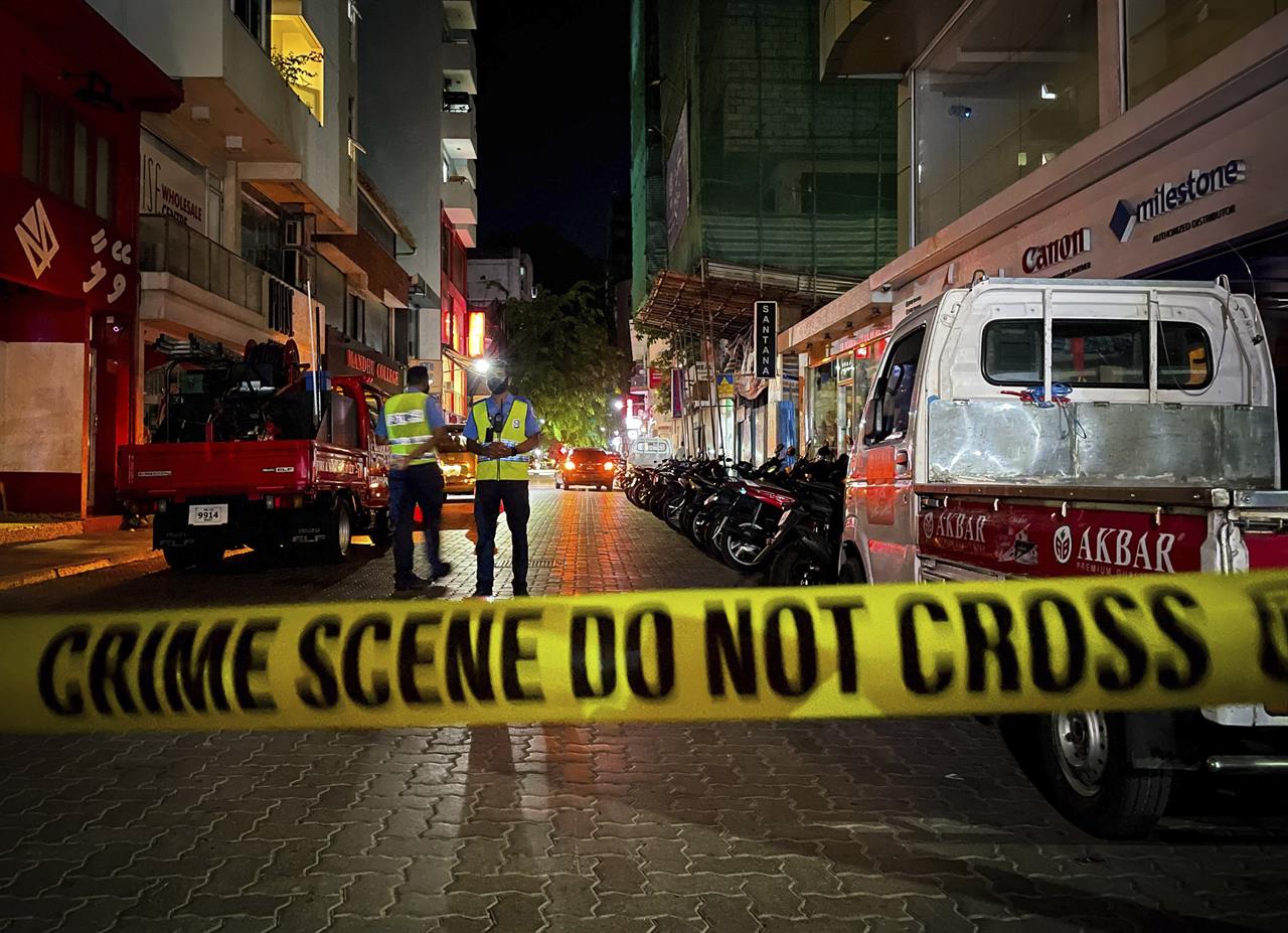 Maldivian police officers secure the area following a blast in Male, Maldives, Thursday, May 6, 2021. Maldives' first democratically elected president and current Parliament Speaker Mohamed Nasheed has been injured in a blast Thursday near his home and was being treated in a hospital in the capital, police said. (AP Photo/Mohamed Sharuhaan)