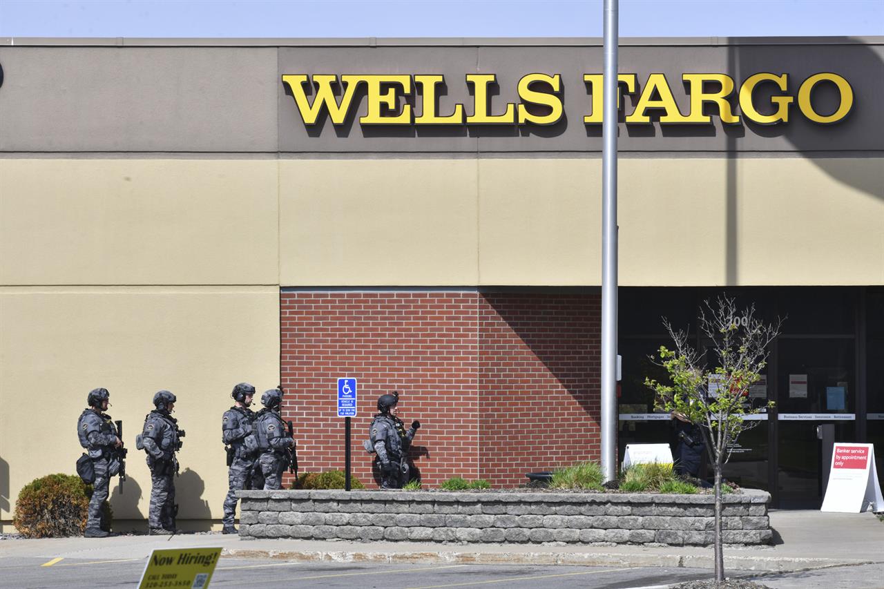 SWAT team officers respond to the scene of a reported hostage situation at the Wells Fargo branch Thursday May 6, 2021, in south St. Cloud, Minn. Police in Minnesota were on the scene Thursday of a reported bank robbery with hostages. (Dave Schwarz/St. Cloud Times via AP)