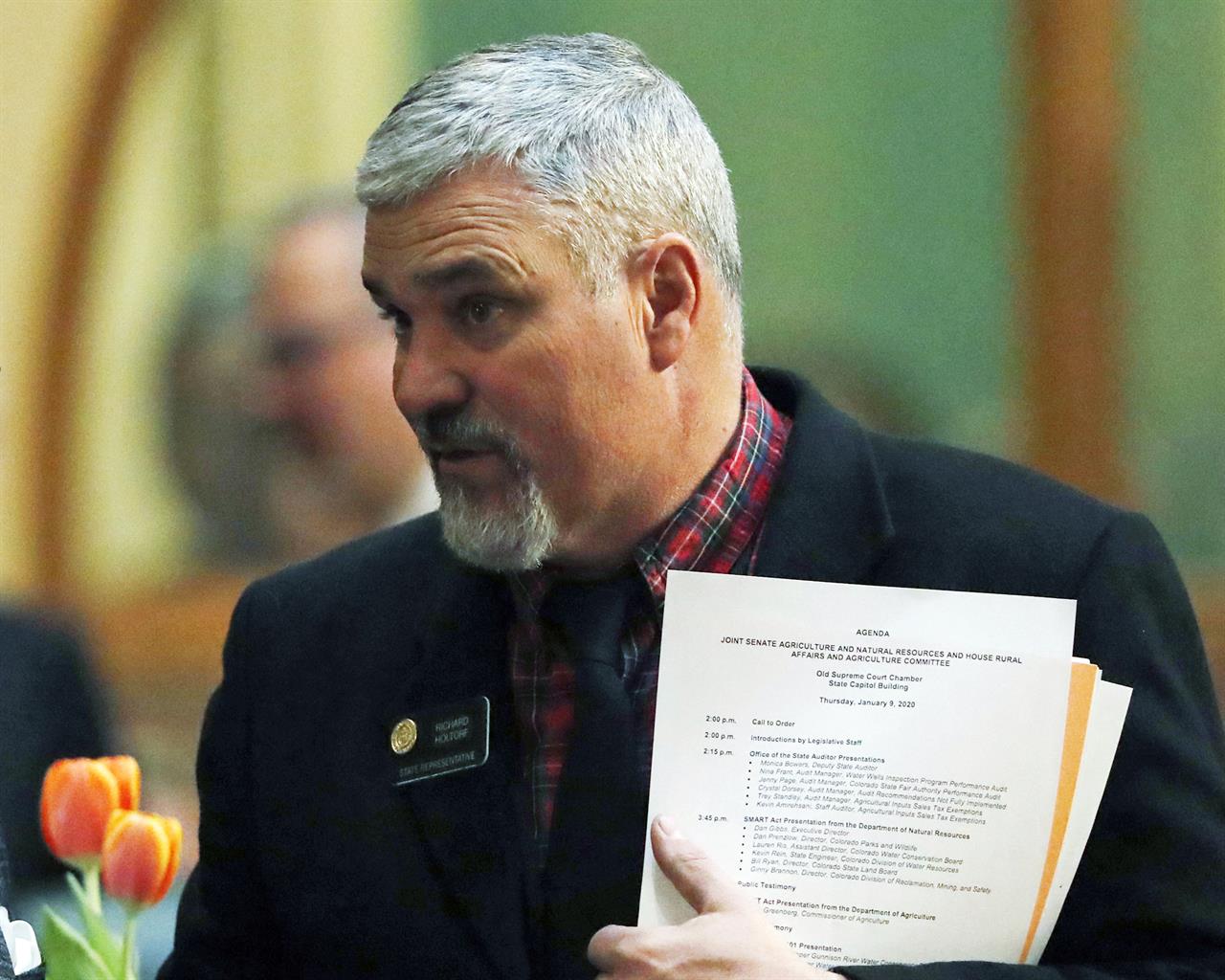 FILE - In this Jan. 9, 2020, file photo, Republican state Rep. Richard Holtorf talks with a fellow representative as they wait for delivery of the State of State speech in the State Capitol in Denver. Holtorf has been reprimanded after calling a colleague "buckwheat" during a floor debate, that provoked angry reactions from Democrats. It wasn't clear to whom Holtorf, directed the remarks to on Wednesday, May 5, 2021, during debate on a stimulus bill. But he quickly said he was using the word as a "term of endearment," furthering angering Democrats, before apologizing. (AP Photo/David Zalubowski,File)