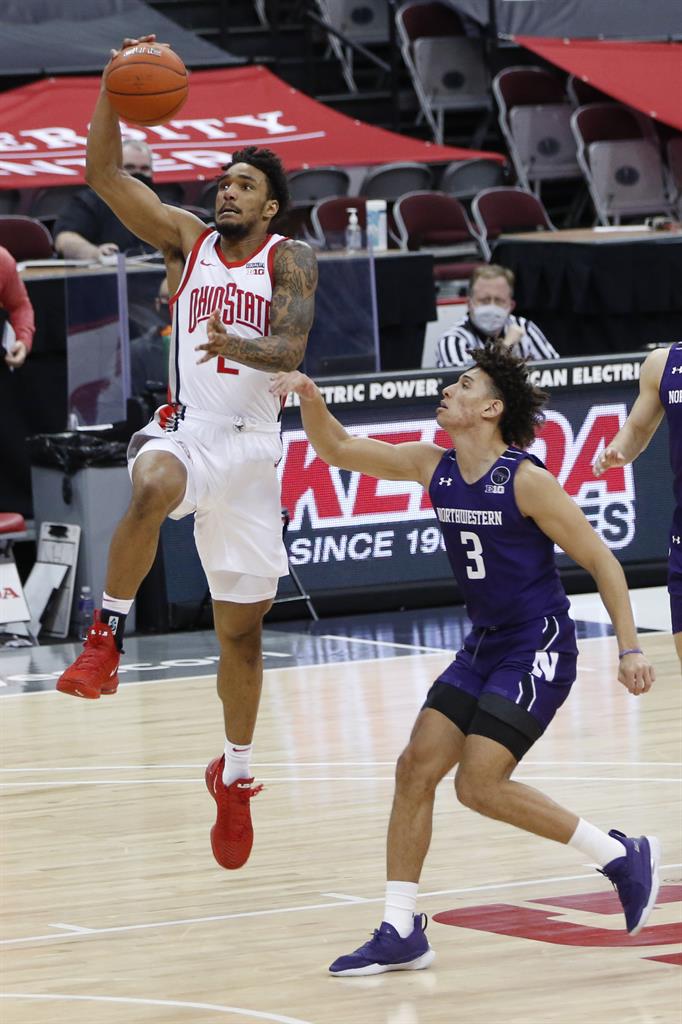 Ohio State's Musa Jallow, left, drives past Northwestern's Ty Berry during the second half of an NCAA college basketball game Wednesday, Jan. 13, 2021, in Columbus, Ohio. (AP Photo/Jay LaPrete)