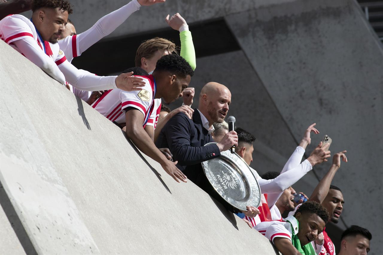 Ajax coach Erik ten Hag, holding the trophy, and players celebrate clinching the Dutch Eredivisie Premier League title after winning the soccer match between Ajax and Emmen with a 4-0 score at the Johan Cruyff ArenA in Amsterdam, Netherlands, Sunday, May 2, 2021. (AP Photo/Peter Dejong)