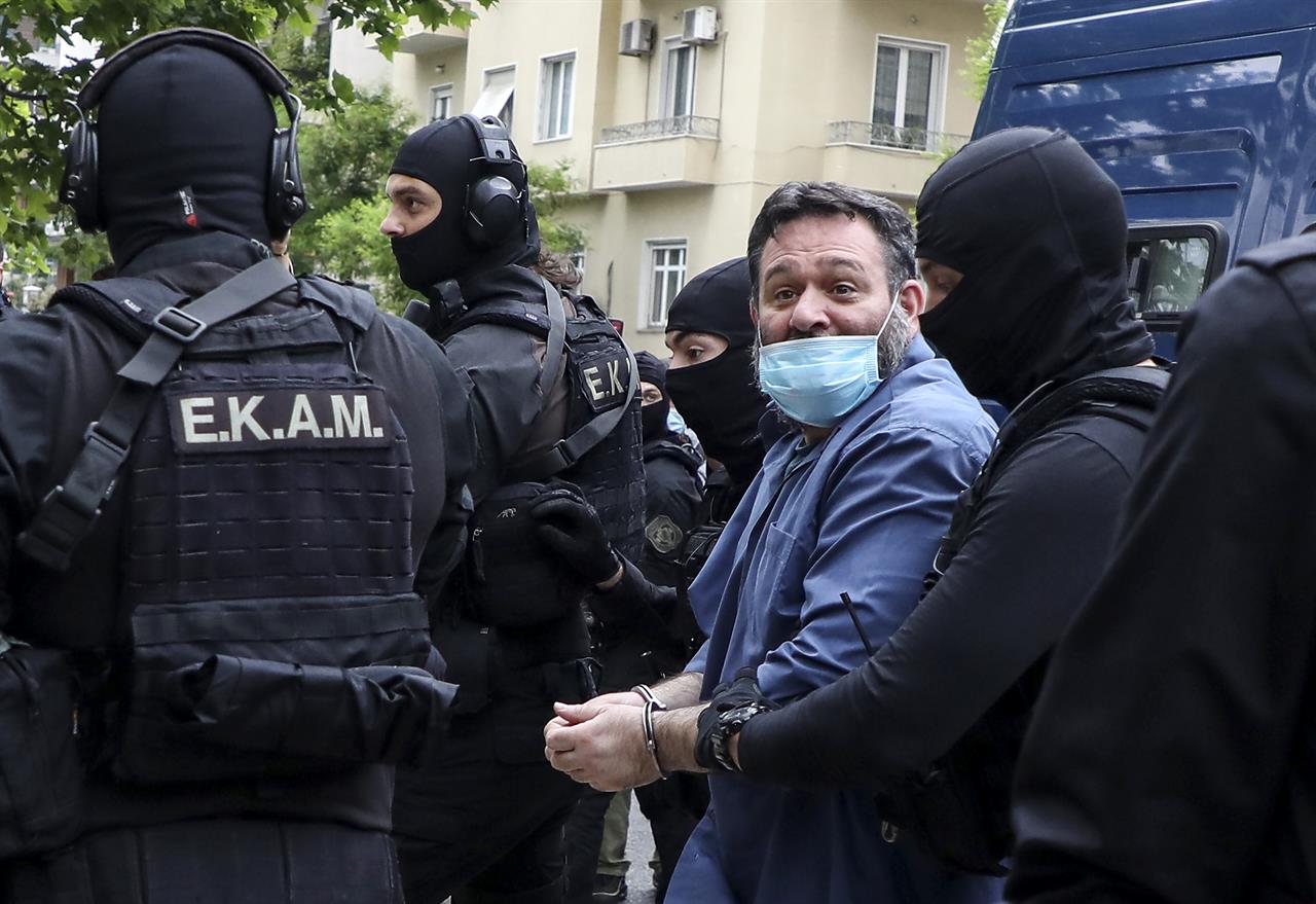 European Parliament member Ioannis Lagos is transferred to the Greek Police headquarters, in Athens, Saturday, May 15, 2021. Lagos arrived in Greece Saturday to serve a 13-year sentence imposed on him last October for being a leading member of the extreme-right Golden Dawn party, which was labeled a criminal organization. (Stelios Stefanou/InTime News via AP)