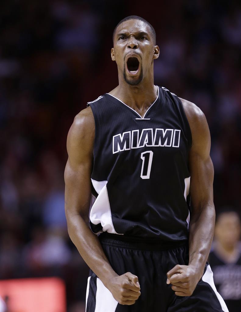 FILE - Miami Heat center Chris Bosh celebrates after scoring during the second half of an NBA basketball game against the New York Knicks, Monday, Feb. 9, 2015, in Miami. Bosh is among those announced Sunday, May 16, 2021 as the 2021 class for the Naismith Memorial Basketball Hall of Fame. (AP Photo/Wilfredo Lee, file)