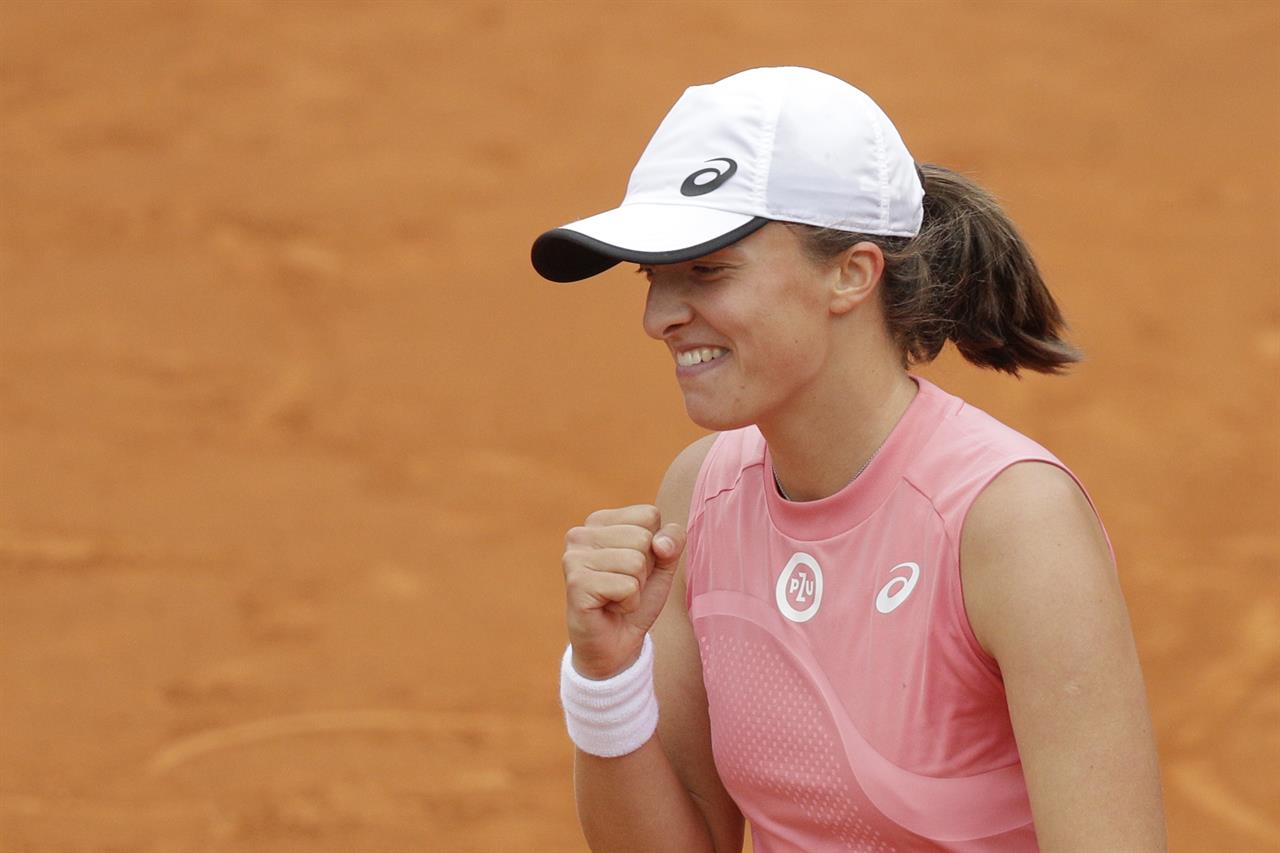 Poland's Iga Swiatek celebrates after defeating Czech Republic's Karolina Pliskova at the final match of the Italian Open tennis tournament, in Rome, Sunday, May 16, 2021. Swiatek won 6-0, 6-0. (AP Photo/Gregorio Borgia)