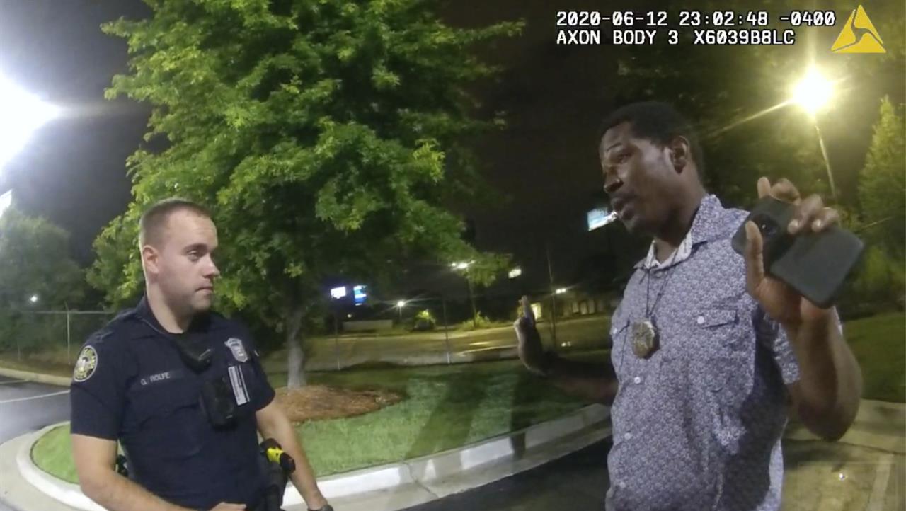 FILE - In this June 12, 2020, file photo from a screen grab taken from body camera video provided by the Atlanta Police Department Rayshard Brooks, right, speaks with Officer Garrett Rolfe, left, in the parking lot of a Wendy's restaurant, in Atlanta. A judge on Friday, June 4, 2021 granted a request from the district attorney in Atlanta to recuse her office from prosecuting the police officer who fatally shot Rayshard Brooks and instructed the state attorney general to appoint another prosecutor. (Atlanta Police Department via AP, File)