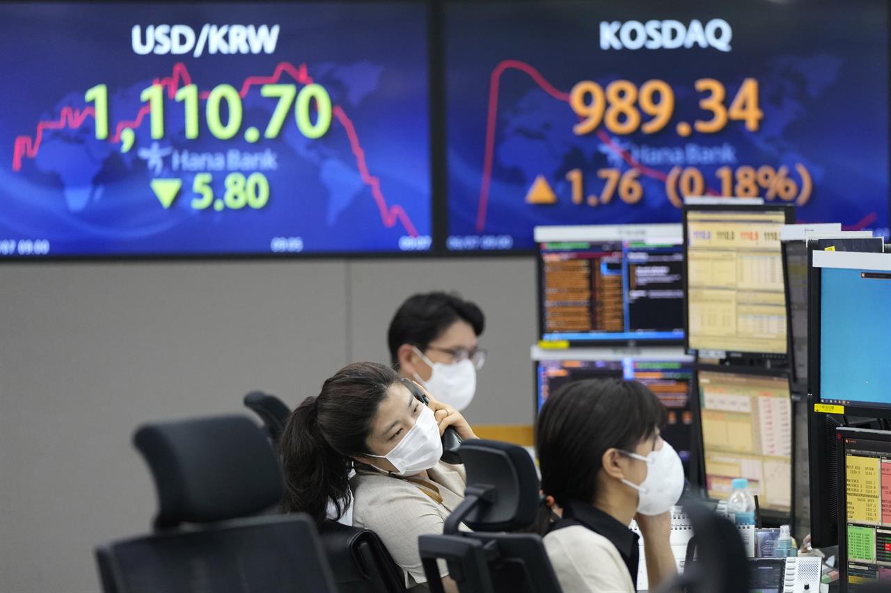 A currency trader talks on the phone at the foreign exchange dealing room of the KEB Hana Bank headquarters in Seoul, South Korea, Monday, June 7, 2021. Asian shares were mixed Monday, as initial euphoria about the gains that closed out last week on Wall Street faded quickly. (AP Photo/Ahn Young-joon)