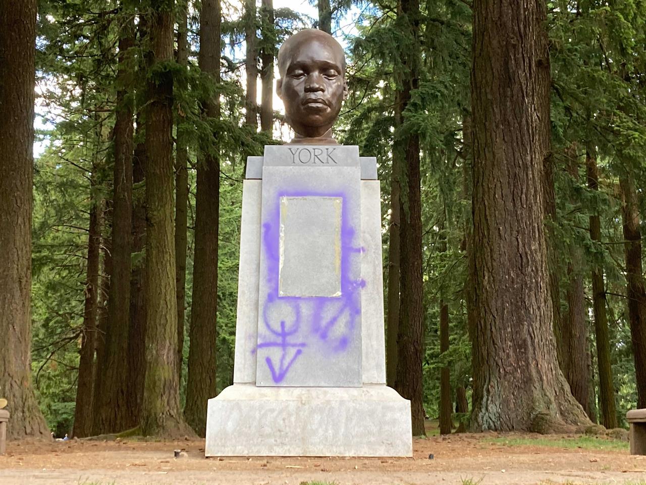 This Thursday, June 10, 2021 photo shows a statue commemorating York, an enslaved Black member of the Lewis and Clark Expedition, after being defaced in Portland, Ore. (Catalina Gaitán/The Oregonian via AP)