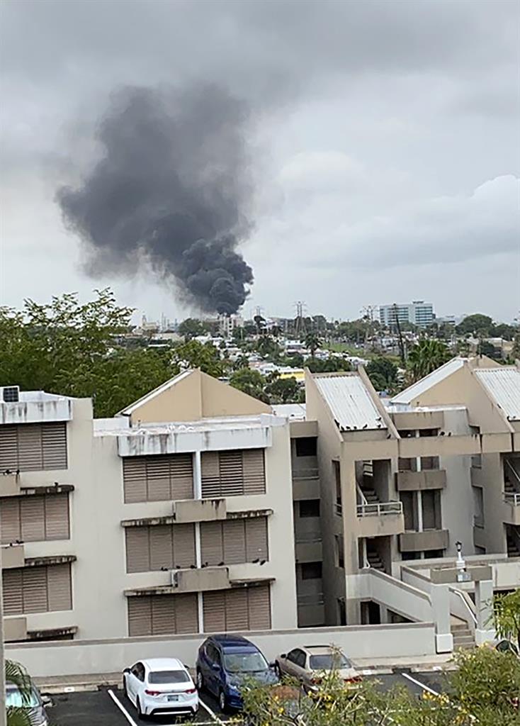 Smoke billows after a large fire at a main substation that left hundreds of thousands of clients in the dark in San Juan, Puerto Rico on Thursday evening, June 10, 2021.(@MadeleenFlores via AP)