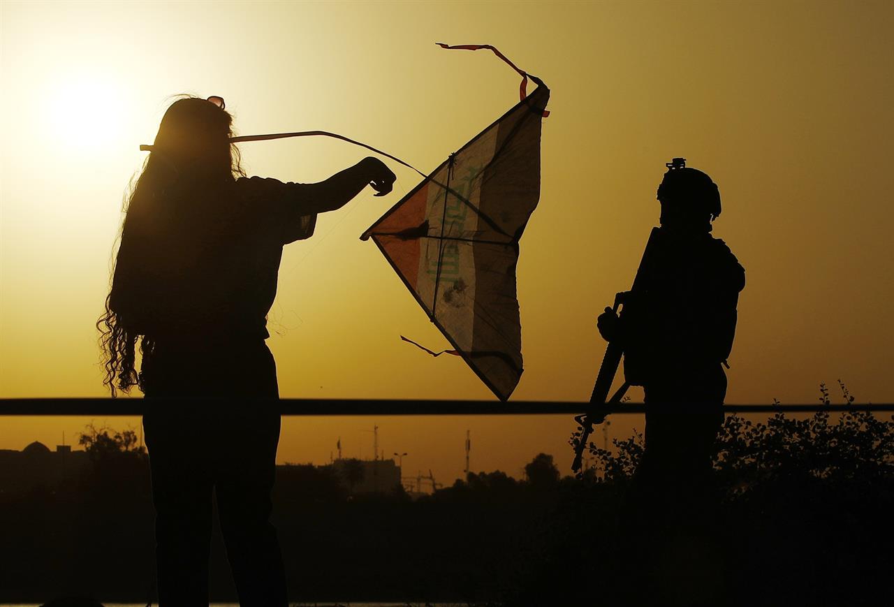 People take part in the Baghdad Kite Festival as the sun sets in Baghdad, Iraq, Saturday, June 5, 2021. (AP Photo/Hadi Mizban)