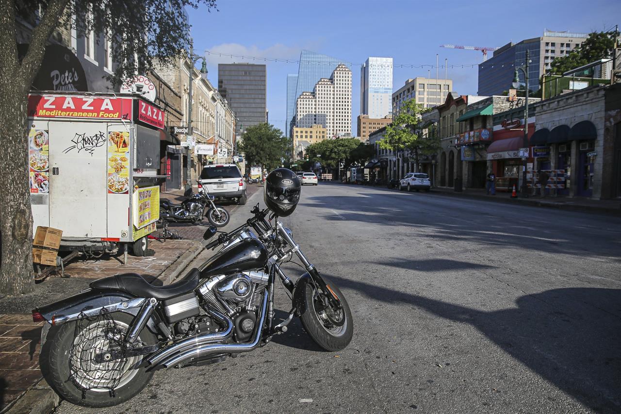 Some abandoned bikes are parked on the streets after a early morning shooting on Saturday, June 12, 2021 in downtown Austin, Texas. Authorities say someone opened fire on the busy entertainment district wounding several people before getting away. (Aaron Martinez/Austin American-Statesman via AP)