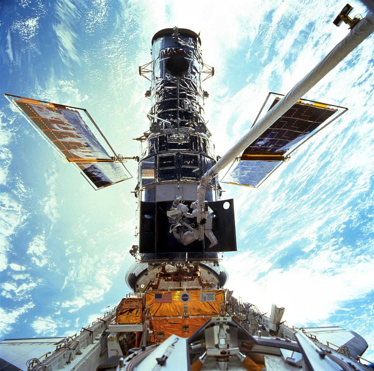 FILE - In this image provided by NASA/JSC, astronauts Steven L. Smith and John M. Grunsfeld are photographed during an extravehicular activity (EVA) during the December 1999 Hubble servicing mission of STS-103, flown by Discovery. The Hubble Space Telescope has been blindsided by computer trouble, with all astronomical viewing halted, NASA said Wednesday, June 16, 2021. The orbiting observatory has been idle since Sunday when a 1980s-era computer that controls the science instruments shut down, possibly because of a bad memory board. (NASA/JSC via AP, File)