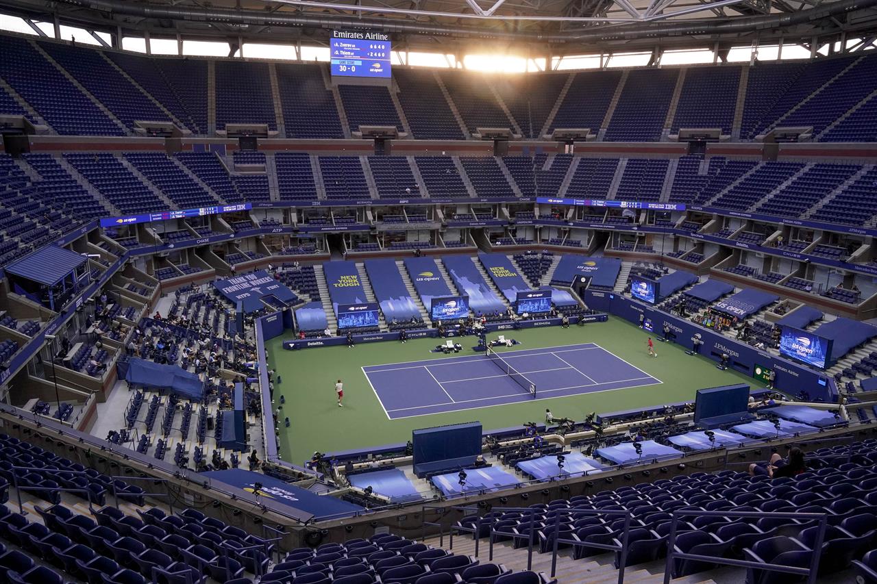 FILE - In this Sept. 13, 2020, file photo, Alexander Zverev, left, of Germany, returns a shot to Dominic Thiem, of Austria, during the men's singles final of the U.S. Open tennis tournament in New York. The U.S. Open will allow 100% spectator capacity throughout its entire two weeks in 2021, a year after spectators were banned from the event because of the coronavirus pandemic, The Associated Press has learned. The U.S. Tennis Association announced Thursday, June 17, that all tickets for courts and grounds passes will go on sale in July. The year’s last Grand Slam tournament is scheduled to be held at Flushing Meadows in New York from Aug. 30 to Sept. 12. (AP Photo/Seth Wenig. File)