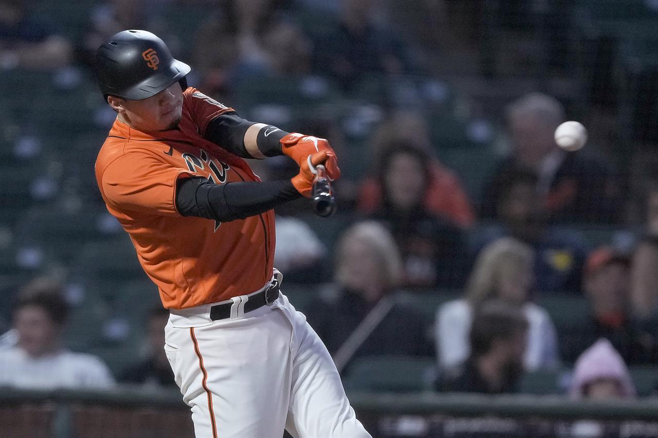 San Francisco Giants' Wilmer Flores hits a single against the Philadelphia Phillies during the fifth inning of a baseball game Friday, June 18, 2021, in San Francisco. (AP Photo/Tony Avelar)