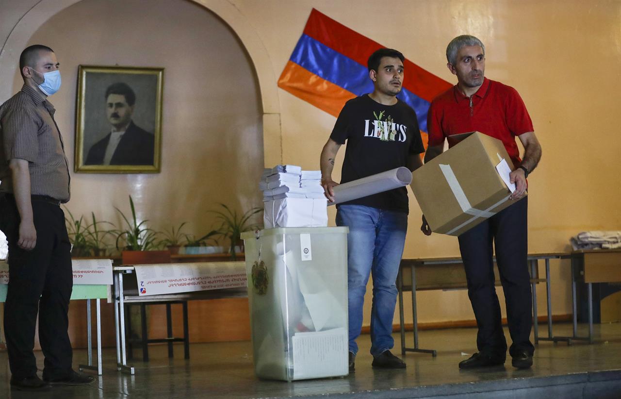 Election officials distribute election attributes to polling stations prior to the upcoming parliamentary elections in Yerevan, Armenia, Saturday, June 19, 2021. Armenians head to the polls Sunday for an early parliamentary election stemming from a political crisis that has engulfed the country in the aftermath of the last year’s fighting with Azerbaijan over the separatist region of Nagorno-Karabakh. (AP Photo/Sergei Grits)