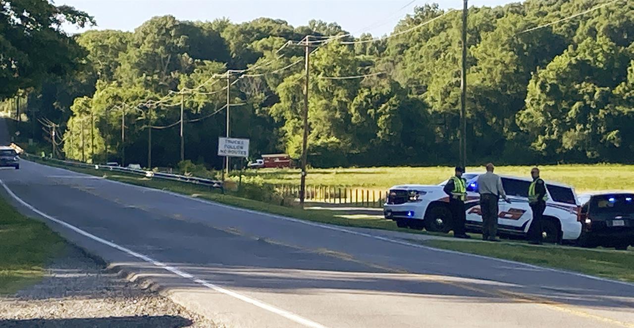 Rockingham County Sheriff Sam Page waits with other officials for the arrival of the State Highway Patrol's helicopter, equipped with infrared technology, to aid in the search for a group of missing rafters on Thursday evening, June 17, 2021, in Eden, N.C. Local officials in North Carolina say the body of a fourth tuber has been found in a river following a deadly accident in which a family on a recreational float went over a dam. One tuber now remains missing Sunday, June 21, following Wednesday night’s accident that involved nine people. (Susan Spear/News & Record via AP)