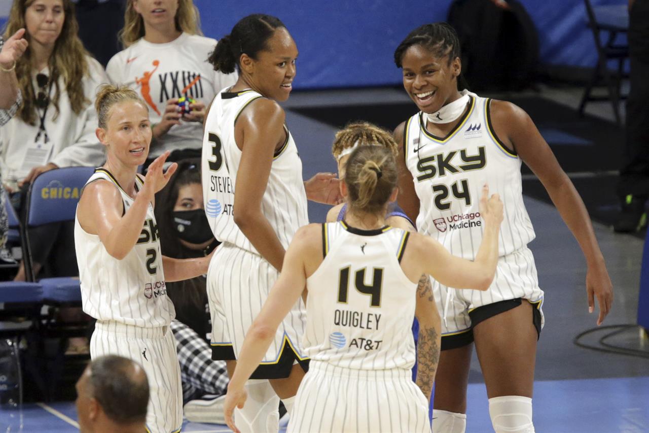 Chicago Sky's Courtney Vandersloot (22), Azurá Stevens (30), Allie Quigley (14) and Ruthy Hebard (24) celebrate after a call in the fourth quarter against Connecticut Sun during a WNBA basketball game Saturday, June 19, 2021, in Chicago. (AP Photo/Eileen T. Meslar)
