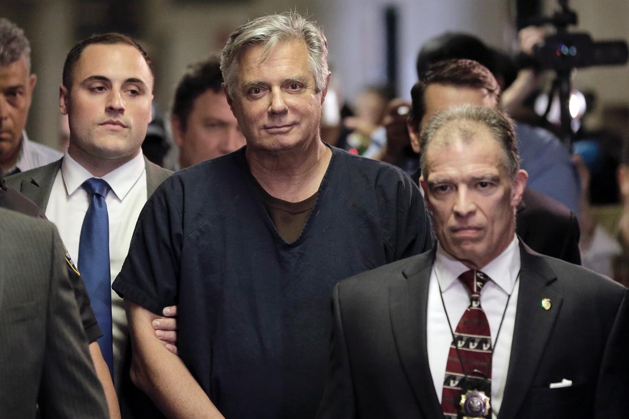 FILE- In this June 27, 2019 file photo, Paul Manafort, center, arrives at court in New York. New York City prosecutors are seeking to have the state’s highest court revive state mortgage fraud charges against Manafort after striking out twice before in lower courts. The Manhattan district attorney’s office sent a letter Tuesday, Nov. 24, 2020, to the state’s chief judge asking permission to challenge an intermediate appeals court’s ruling last month, which upheld a judge’s decision to dismiss the case on double jeopardy grounds.(AP Photo/Seth Wenig, File)