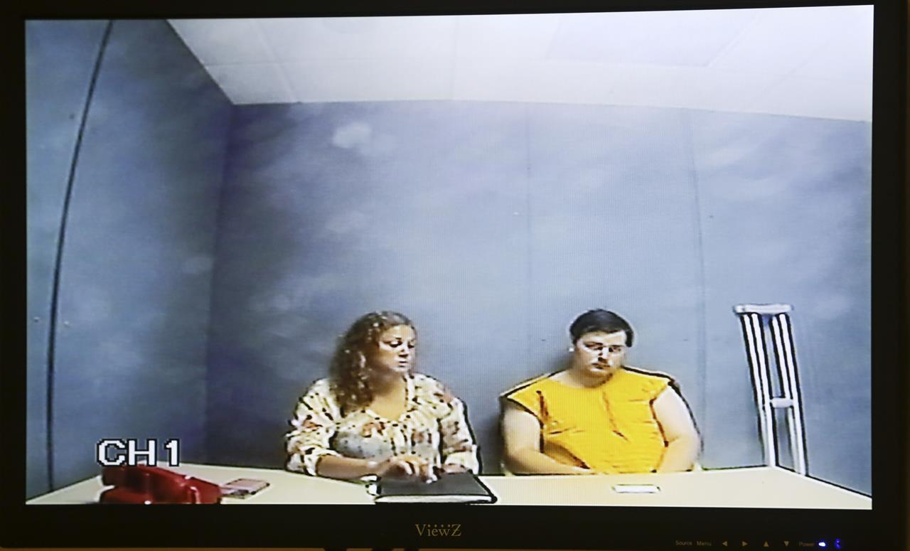 FILE - In this June 16, 2021, file photo, Alexander Ken Jackson, right, appears for his initial court appearance via video conference with his attorney assistant public defender Lindsay Garner at the Linn County Courthouse in Cedar Rapids, Iowa. Emergency responders and a hospital that treated the Cedar Rapids man for a gunshot wound after he allegedly killed his parents and sister must share his medical records with prosecutors, a judge ruled Tuesday, July 20, 2021. (Jim Slosiarek/The Gazette via AP, File)