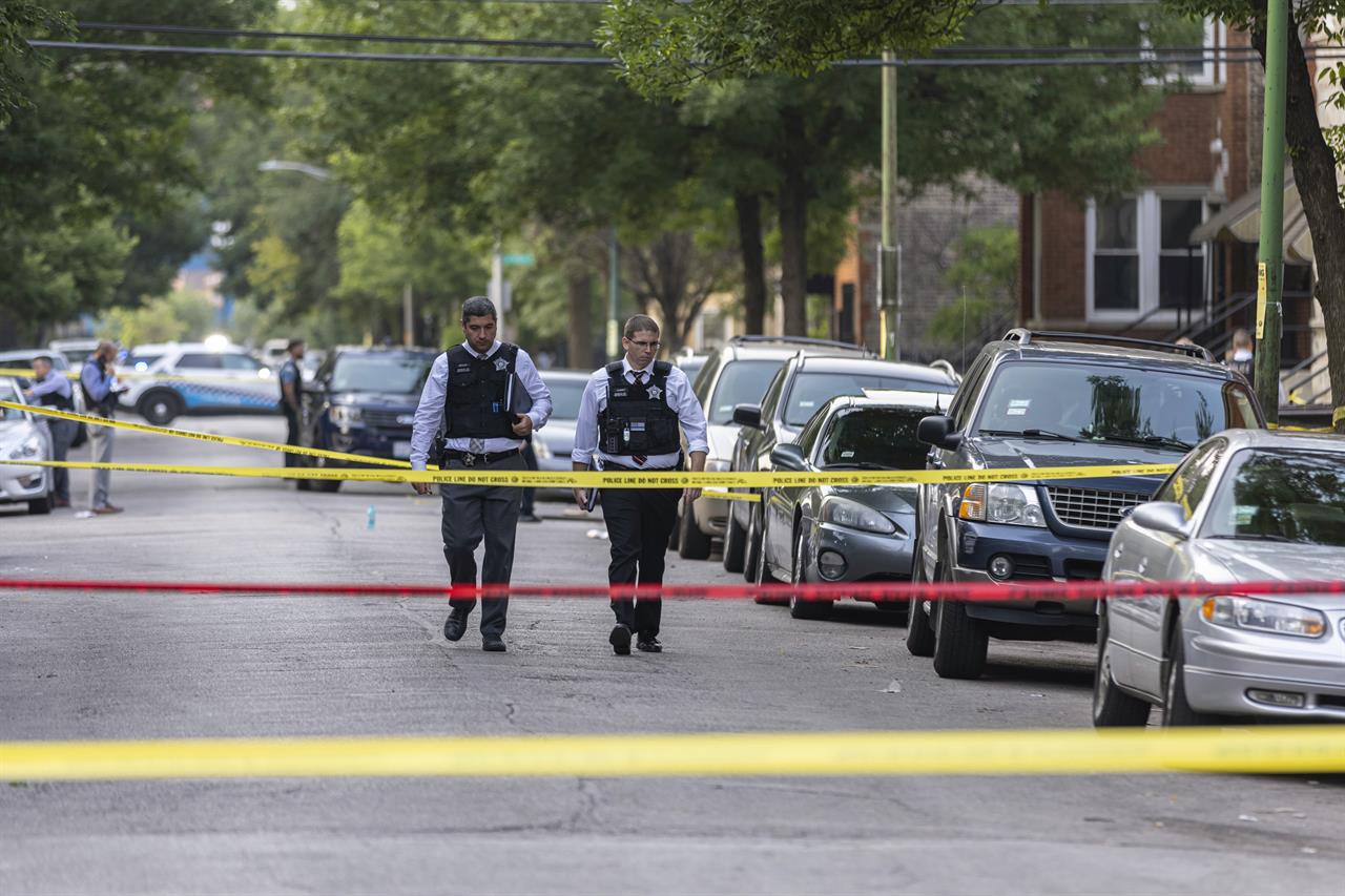 Police investigate the scene of a shooting near 1324 S Christiana Ave in Lawndale, on Chicago’s West Side, Wednesday, July 21, 2021. (Anthony Vazquez/Chicago Sun-Times via AP)