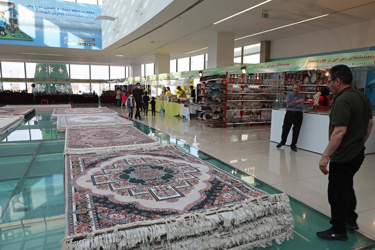 Piles of plush Iranian- made carpets line the floors of a shopping center in northern Iraq, hosting traders from neighbouring Iran, in the city of Dohuk, in the Kurdish-run northern region of Iraq, Wednesday, Jan. 20, 2021. At least 24 businesses from 15 Iranian cities offer hope that the spangle of their ornate handicrafts might offer a lifeline out of poverty for Iranians whose country's economy is in tatters amid crippling sanctions. (AP Photo/Rashid Yahya)