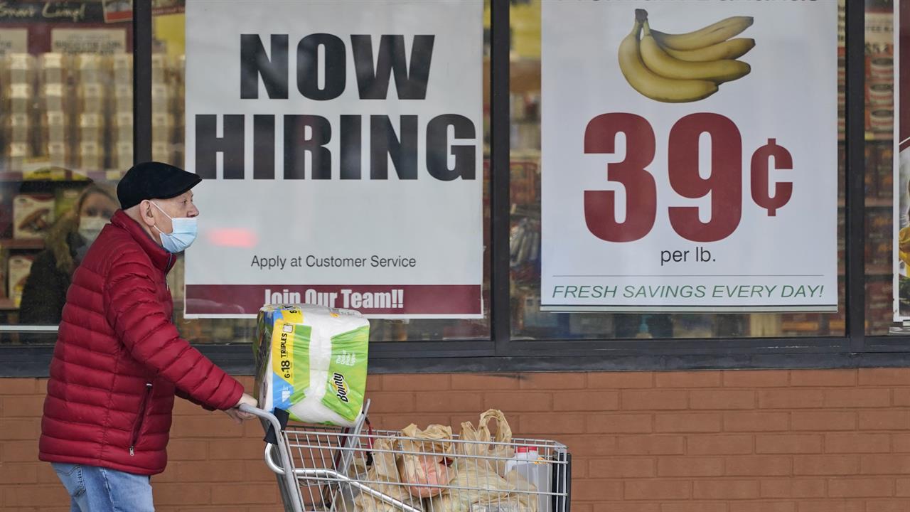 FILE - A man walks out of a Marc's Store, Friday, Jan. 8, 2021, in Mayfield Heights, Ohio. Fewer Americans applied for unemployment benefits last week, lowering claims to 900,000, still a historically high level that points to further job cuts in a raging pandemic. (AP Photo/Tony Dejak, file)