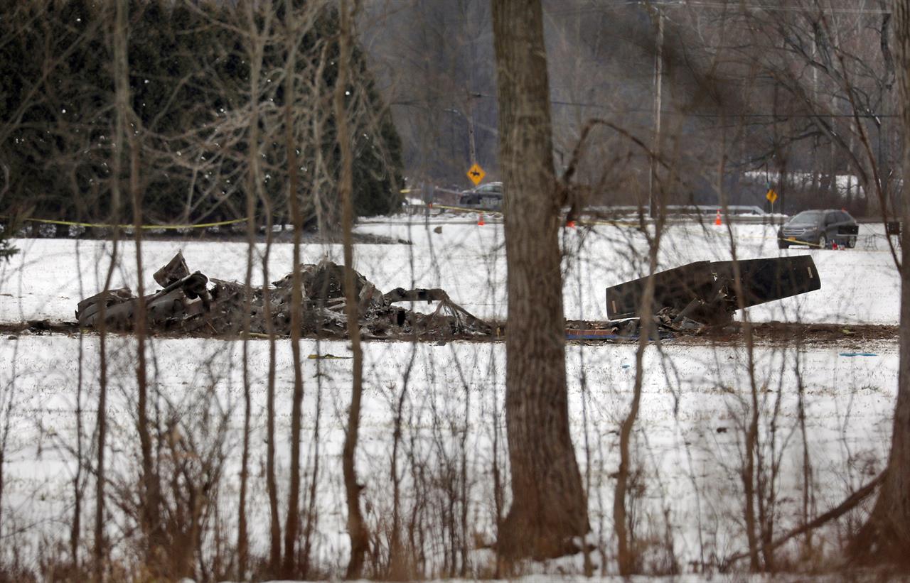 The wreckage of a UH-60 Black Hawk medical evacuation helicopter sits in a field in Mendon, NY., Thursday, Jan. 21, 2021. Three National Guard members were killed in the crash Wednesday evening Jan. 20. (Tina MacIntyre-Yee/Democrat & Chronicle via AP)