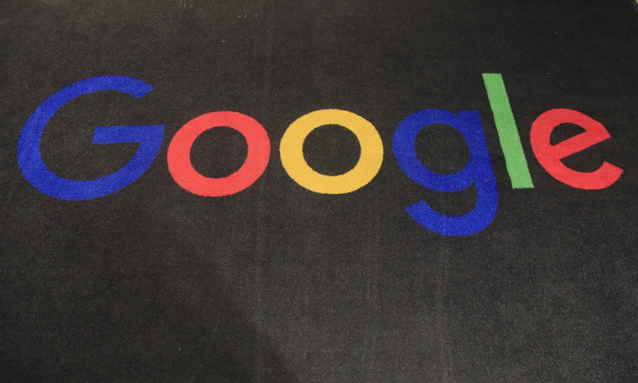 FILE - In this Monday, Nov. 18, 2019 file photo, the logo of Google is displayed on a carpet at the entrance hall of Google France in Paris. After months of talks, Google France and the Alliance de la Presse d'Information Generale said Thursday Jan. 21, 2021, paving the way for the internet giant to make digital copyright payments for online news content. (AP Photo/Michel Euler, File)