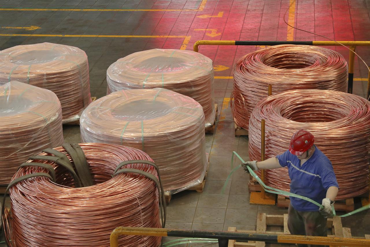 A man works at a factory producing power grid equipment and cable in Nantong city in east China's Jiangsu province Tuesday, July 27, 2021. China's manufacturing growth in July slowed to its lowest level in 15 months as export demand weakened and factories coped with disruptions in supplies of raw materials and components, two surveys found. (Chinatopix via AP)