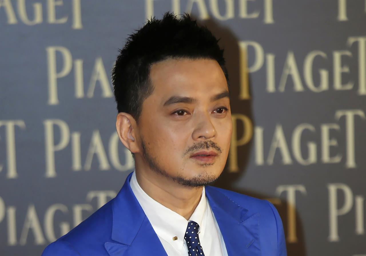 In this Saturday, April 13, 2013, file photo, Hong Kong singer Anthony Wong Yiu-ming poses for photographers on the red carpet of the 32nd Hong Kong Film Awards in Hong Kong. Wong was arrested Monday, Aug. 2, 2021, by the city's anti-corruption watchdog, over accusations of corrupt conduct during a 2018 election, the latest move by authorities amid a crackdown on political dissent in the city. (AP Photo/Vincent Yu, File)