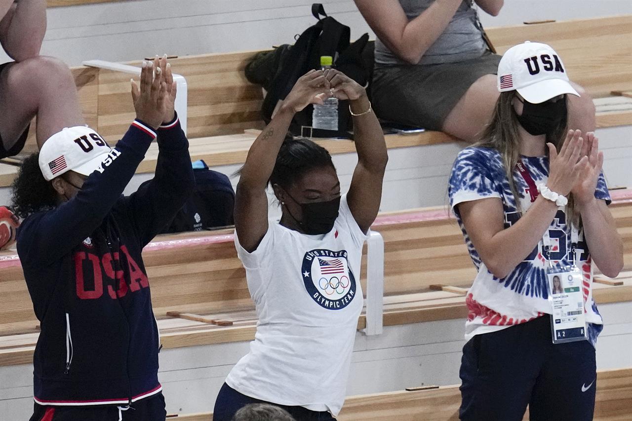 Simone Biles of the United States, center, celebrates after teammate Mykayla Skinner won the silver medal in the vault during the artistic gymnastics women's apparatus final at the 2020 Summer Olympics, Sunday, Aug. 1, 2021, in Tokyo, Japan. (AP Photo/Gregory Bull)