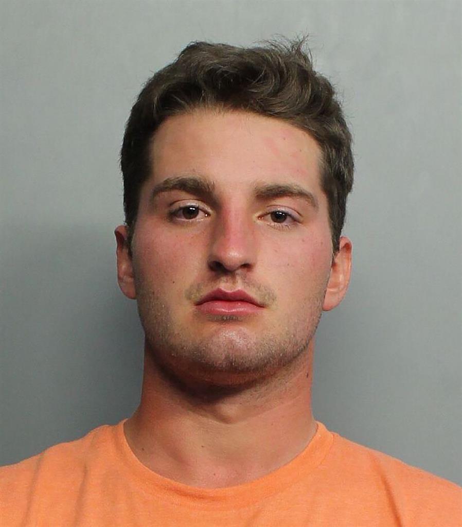 This booking image provided by the Miami-Dade Police Department shows Maxwell Berry, 22, of Norwalk, Ohio, who was arrested Saturday, July 21, 2021, at Miami International Airport and charged with three counts of misdemeanor battery, according to a Miami-Dade police report. Berry is accused of groping two female flight attendants and punching a male flight attendant during a flight from Philadelphia to Miami, officials said. (Miami-Dade Police Department via AP)