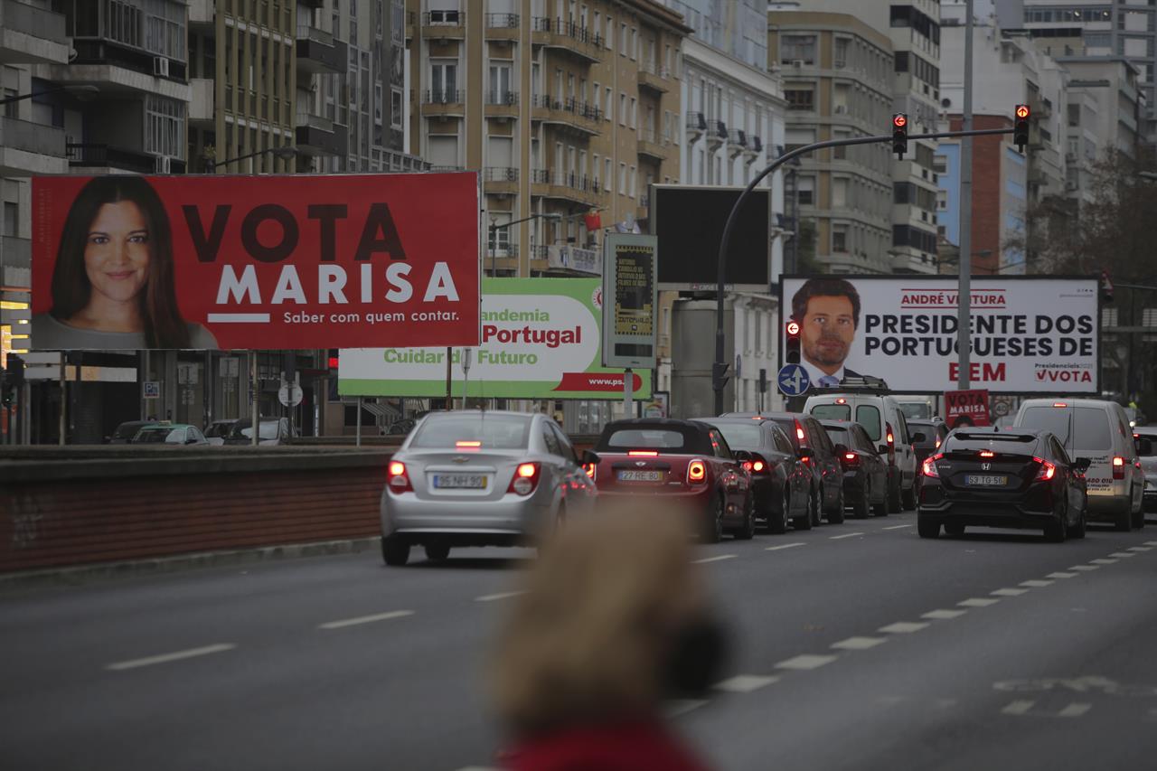 Cars drive past election campaign billboards for presidential candidates Marisa Matias, left, and Andre Ventura, right, in Lisbon, Tuesday, Jan. 19, 2021. Portugal holds a presidential election on Sunday, Jan. 24, 2021 and the moderate incumbent candidate is widely seen as the sure winner. But an intriguing question for many Portuguese is how well a brash new populist challenger fares in the ballot. Mainstream populism is a novelty in Portugal. (AP Photo/Armando Franca)