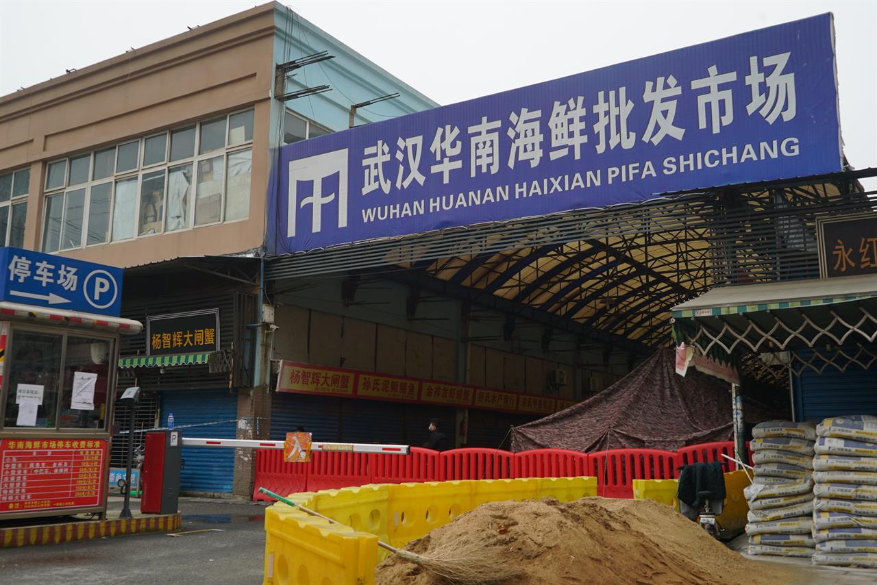 FILE - In this Jan. 21, 2020, file photo, the Wuhan Huanan Wholesale Seafood Market, where a number of people related to the market fell ill with a virus, sits closed in Wuhan in central China's Hubei province. The Chinese city of Wuhan is looking back on a year since it was placed under a 76-day lockdown beginning Jan. 23, 2020. (AP Photo/Dake Kang, File)