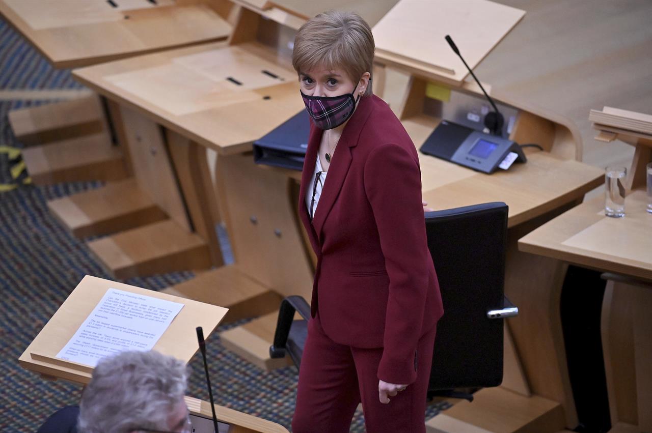 Scotland's First Minister Nicola Sturgeon looks on during First Minister's Questions at the Scottish Parliament in Edinburgh, Thursday, Nov. 19, 2020. (Jeff J Mitchell/PA via AP)