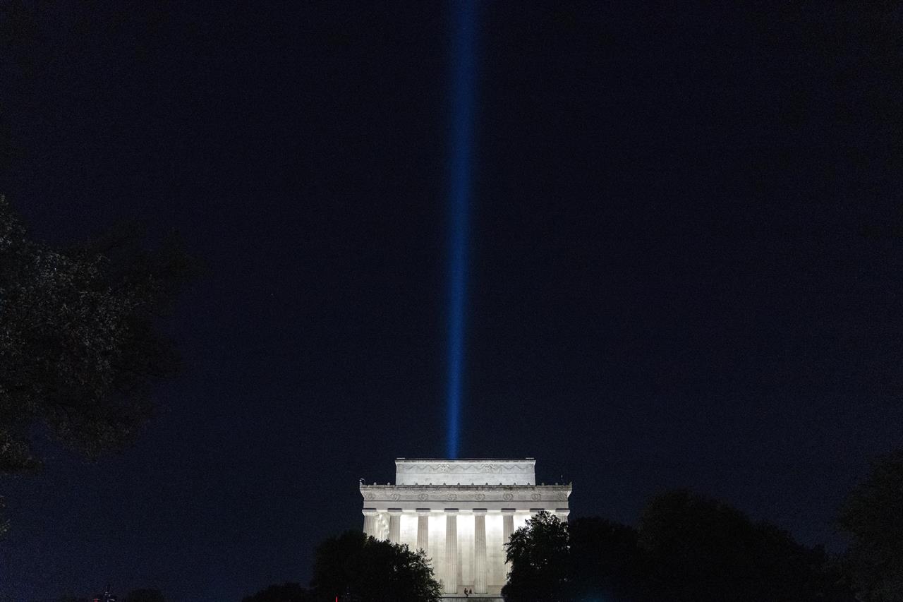 A beam of light is visible over the Lincoln Memorial, the day before the 20th anniversary of the Sept. 11 terrorist attacks, as part of the Towers of Light Tribute near the Pentagon, Friday Sept. 10, 2021, in Washington. (AP Photo/Jose Luis Magana)