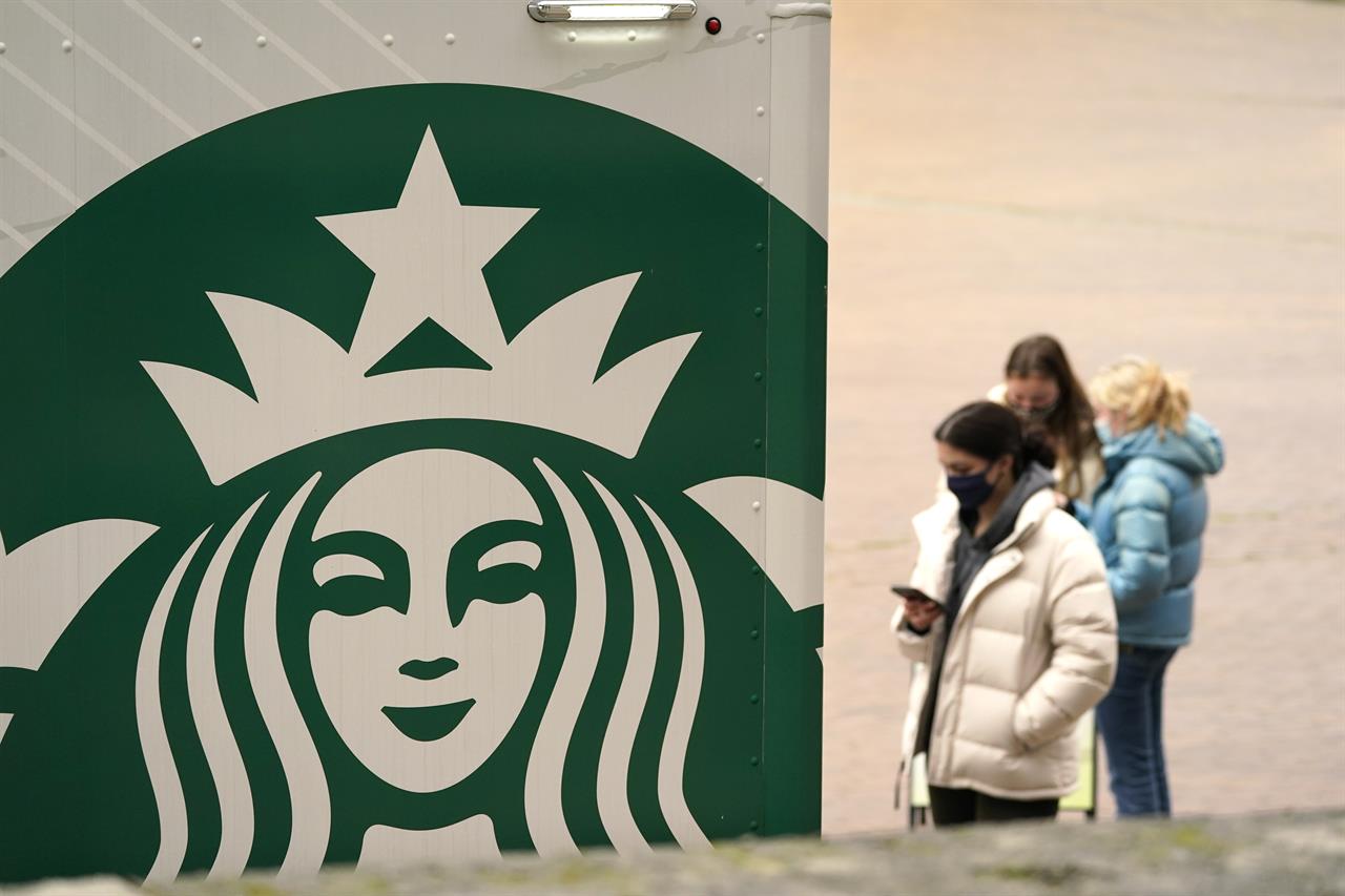 A Starbucks coffee truck continues to serve students and staff in an otherwise nearly deserted Red Square on the University of Washington campus Monday, Jan. 25, 2021, in Seattle. Starbucks’ recovery slowed at the end of last year as U.S. coronavirus cases mounted, but the coffee titan says it’s confident its U.S. business will fully recover by March. The Seattle-based company said Tuesday, Jan. 26, 2021 that its global sales at stores opened at least a year fell 5% in the October-December period. That was an improvement from the prior quarter, but it was still a bigger decline than the 4% drop Wall Street was expecting, according to analysts polled by FactSet. (AP Photo/Elaine Thompson)