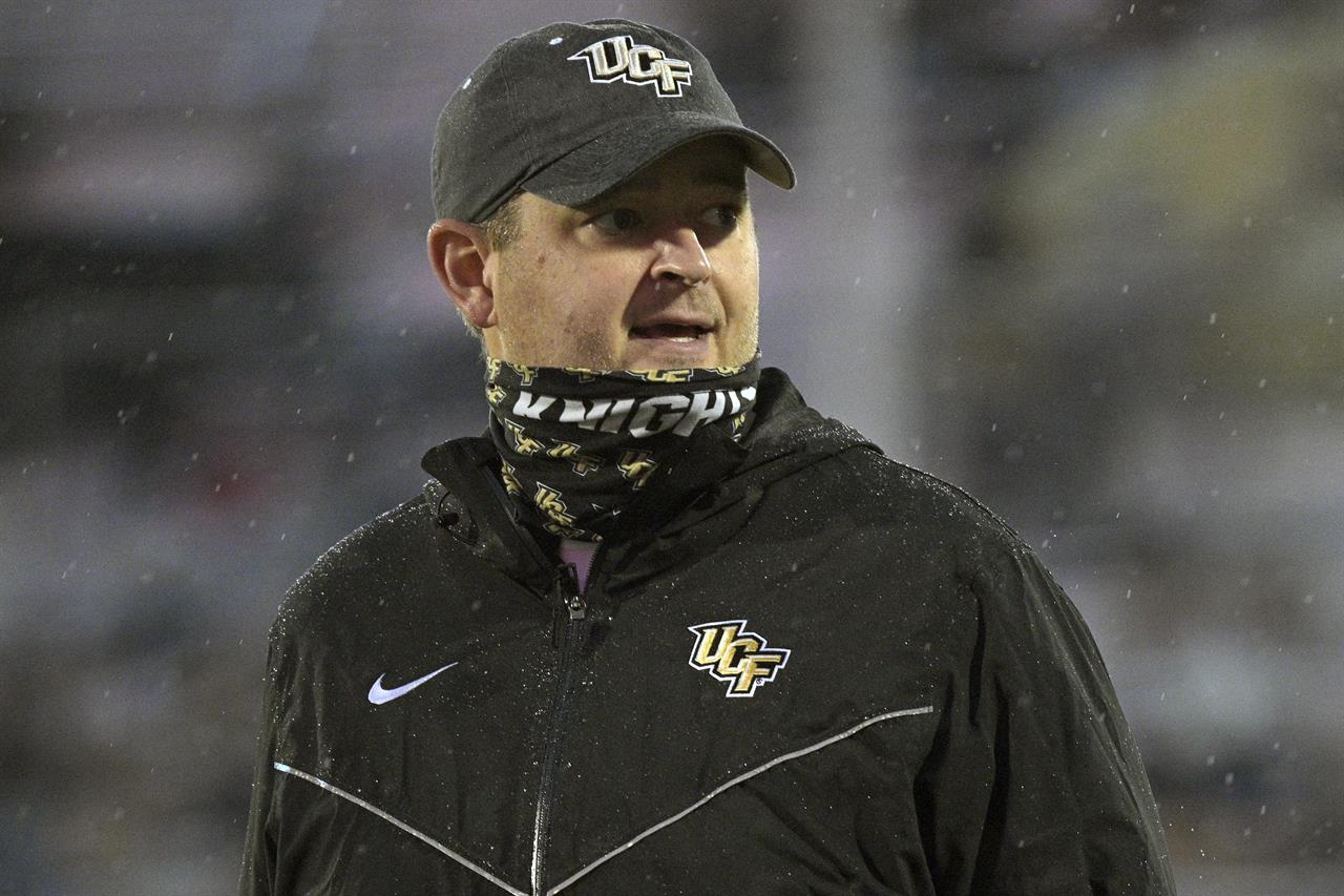 FILE - Central Florida head coach Josh Heupel watches warmups before an NCAA college football game against Tulsa in Orlando, Fla., in this Saturday, Oct. 3, 2020, file photo. Josh Heupel is leaving UCF to become the next Tennessee coach, a person with knowledge of the situation told The Associated Press on Wednesday, Jan. 27, 2021. (AP Photo/Phelan M. Ebenhack, File)