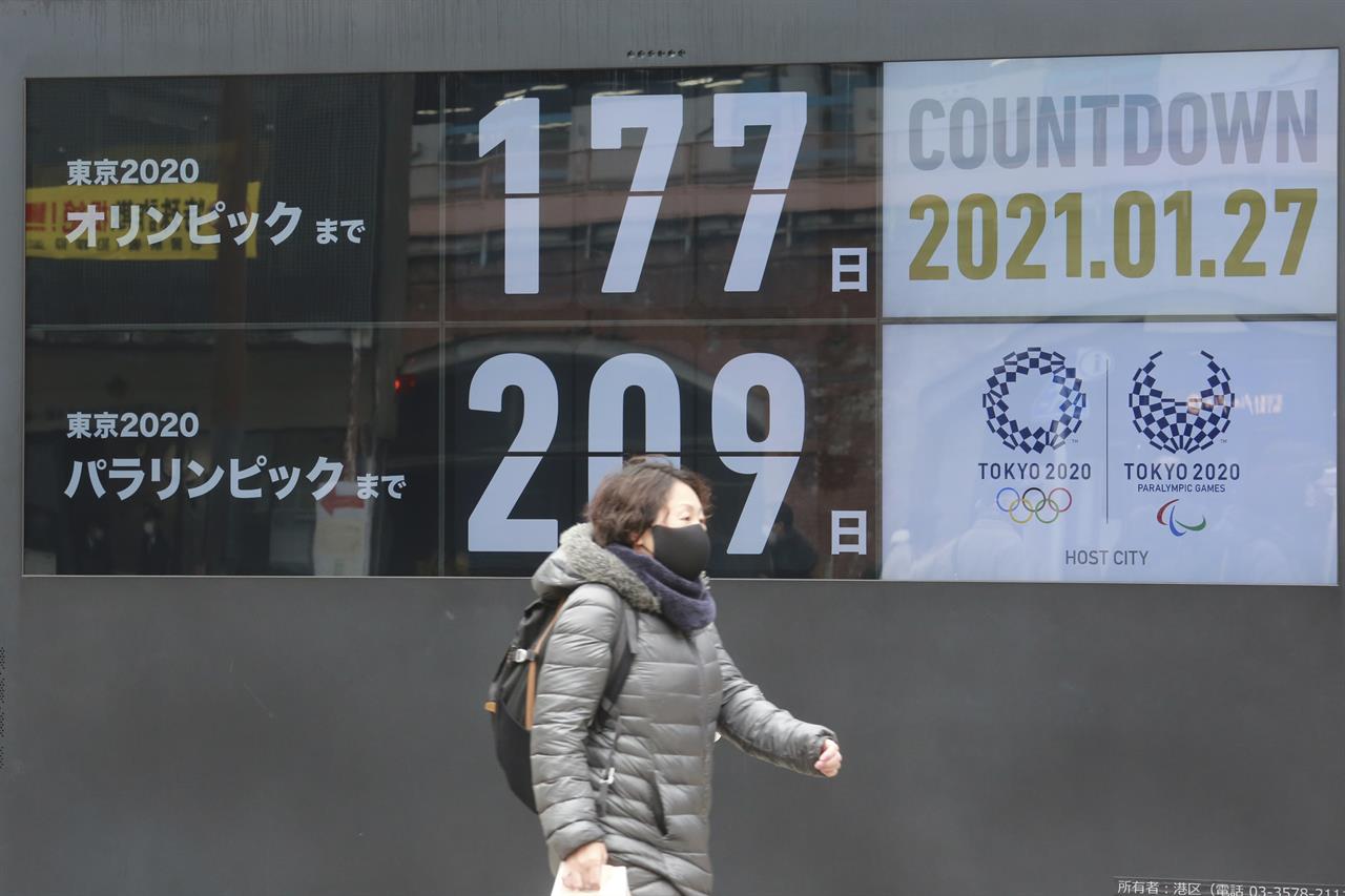 A woman walks past a countdown clock for Tokyo Olympic and Paralympic Games in Tokyo, Wednesday, Jan. 27, 2021. (AP Photo/Koji Sasahara)