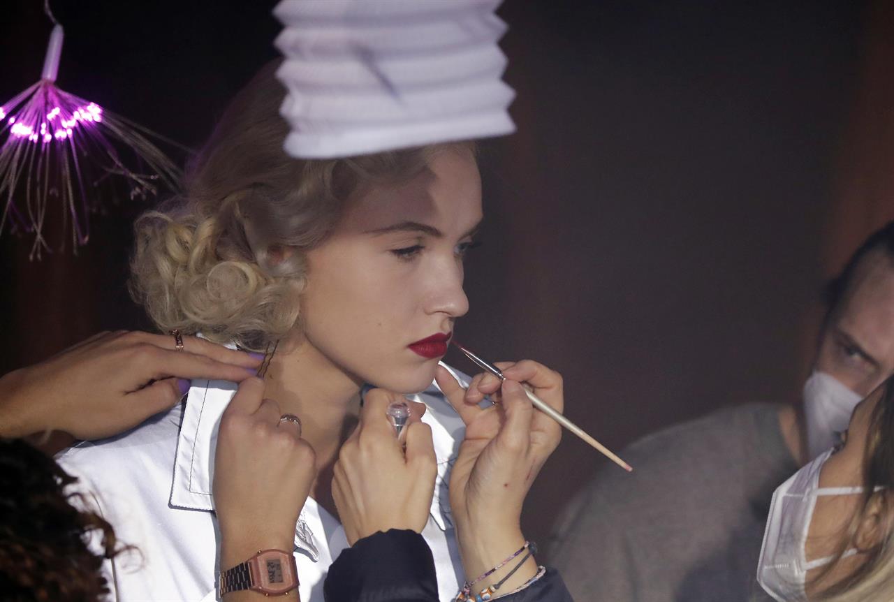 Model Michaela Tomanova has her makeup retouched during the shoot for Julien Fournie's Haute Couture Spring/Summer 2021 fashion collection for a digital presentation of the fashion week, in Paris, Thursday, Jan. 7, 2021. With shows taking place behind closed doors due to the virus pandemic, some designers such as Julien Fournie are becoming versatile: Getting their designs out to the public by making a film of their collection and streaming it online. (AP Photo/Francois Mori)