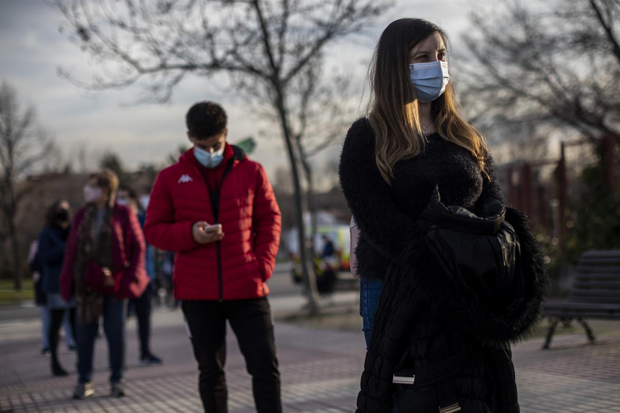 People queue for a rapid antigen test for COVID-19 in Alcobendas, outskirts of Madrid, Spain, Wednesday, Jan. 27, 2021. Health authorities in Spain are complaining that they are running short of COVID-19 vaccines due to delays in deliveries by pharmaceutical companies. Spain along with the rest of the European Union has suffered delays since Pfizer announced two weeks ago that it would reduce deliveries temporarily during a plant upgrade. (AP Photo/Bernat Armangue)